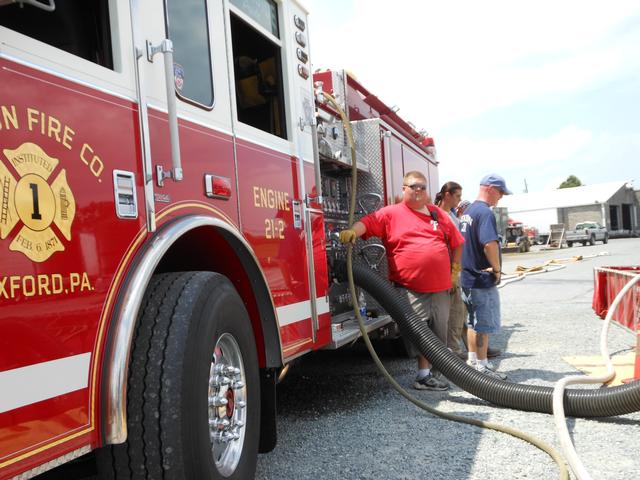 President Bill &quot;Bucket&quot; Goodley pumping Engine 2 at a water supply drill.